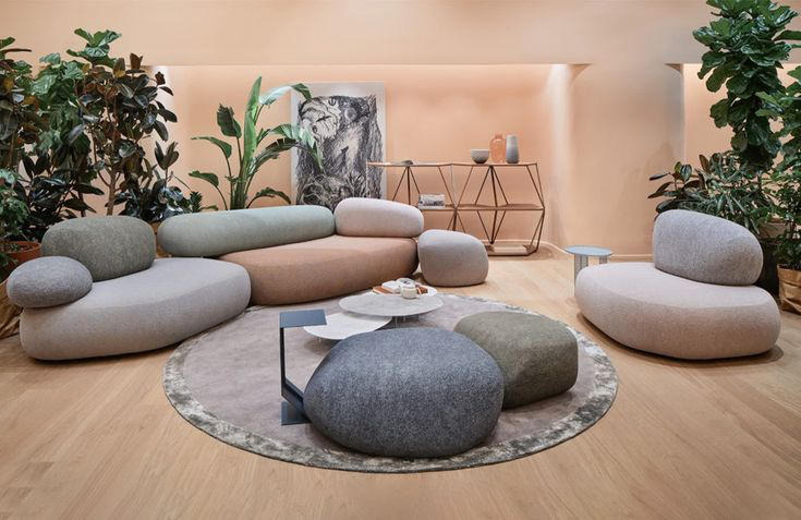Beige modular sofa with rounded shapes in a compact neutral living room