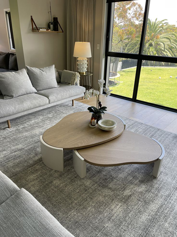 Three modular coffee table layout scenarios in a compact warm minimalist living room